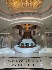 a large lobby with a staircase and a chandelier at Mirage Hotel & SPA - Struga in Struga +54 photos