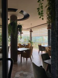 a restaurant with tables and chairs and a large window at Mirage Hotel & SPA - Struga in Struga