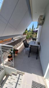 a view of a patio with a table and chairs at Venetia' s house in Kalamata