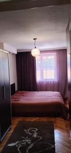 a bedroom with a large bed and a window at kvartira in Kutaisi