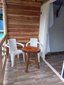 a table and two chairs on a porch at La Cabañita VIP Amanecer in Minca +5 photos