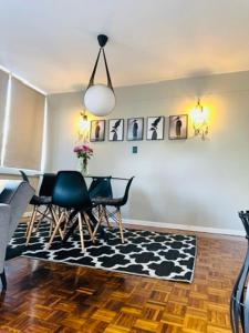 a living room with a dining room table and chairs at Home By The Sea in Gqeberha +26 photos