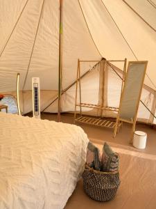 a tent with a basket next to a bed at Hanımın Çiftliği Tents&Drinks in Fethiye