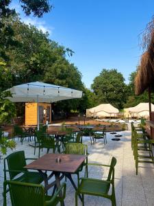 an outdoor patio with tables and chairs and umbrellas at Hanımın Çiftliği Tents&Drinks in Fethiye
