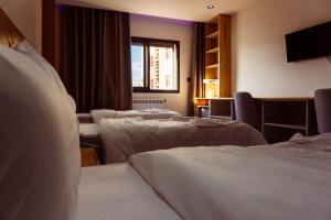 a hotel room with three beds and a window at Hostel Tamim in Fort de lʼEau +55 photos