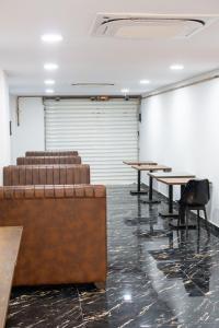 a room with tables and chairs in a room at Hostel Tamim in Fort de lʼEau