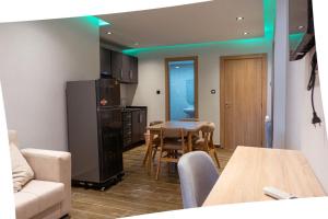 a living room with a kitchen with a table and chairs at Hostel Tamim in Fort de lʼEau