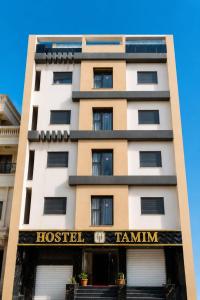a building with a hotel tamim on it at Hostel Tamim in Fort de lʼEau