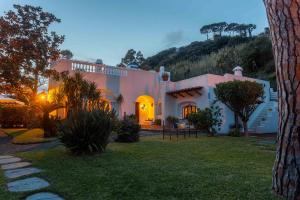 a large house with a garden in front of it at Villa Le Pagine Bianche in Lacco Ameno