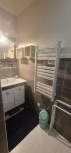 a small bathroom with a sink and a toilet at La maison dans les vignes in Châteauneuf-sur-Charente +6 photos