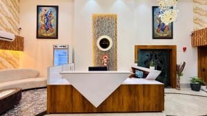 a living room with a table and a fireplace at Hotel Aventus Grand in Indore