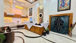 a lobby with a fireplace and a waiting room at Hotel Aventus Grand in Indore