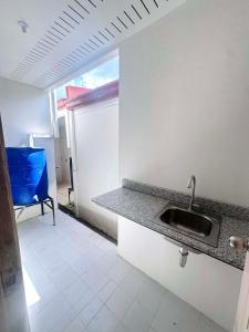 a kitchen with a sink and a counter top at Two Br-House with Carport in Ormoc