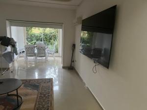 a living room with a flat screen tv on a wall at Marina Golf 7 in Asilah