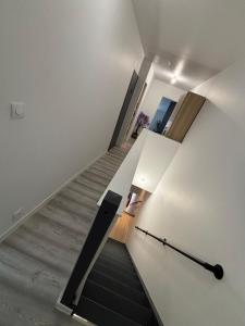 a staircase in a house with a white wall at Le flocmagny in Chalons en Champagne