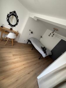 a bedroom with a bed and a mirror on the wall at Le flocmagny in Chalons en Champagne