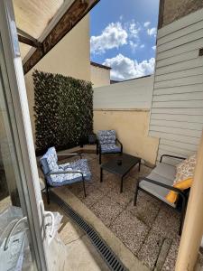 a patio with two chairs and a table at Le flocmagny in Chalons en Champagne
