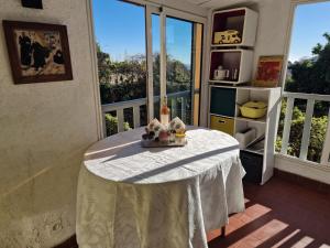 a table with a white table cloth on a balcony at Maison Diana in Vence