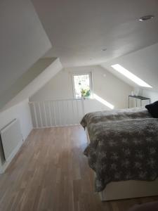 a attic bedroom with a bed and a window at Önnestad guest house in Önnestad