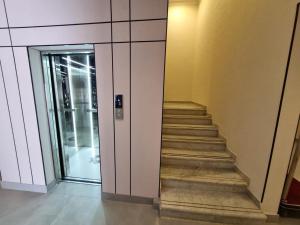 a staircase in a building with a glass door at مساكن للشقق الفندقيه in Riyadh +8 photos
