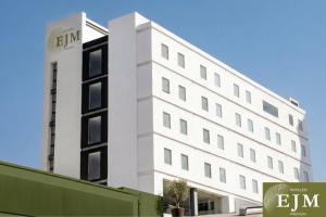 a white building with the word emm on it at Hotel EJM PREMIUM in Irapuato