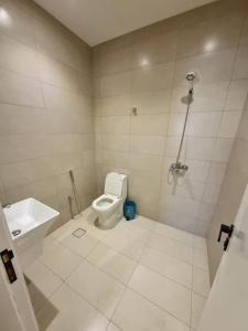 a white bathroom with a toilet and a sink at مساكن للشقق الفندقيه in Riyadh