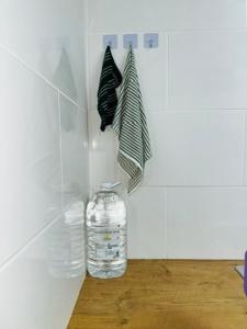a bottle of water on a counter with a towel at Home By The Sea in Gqeberha