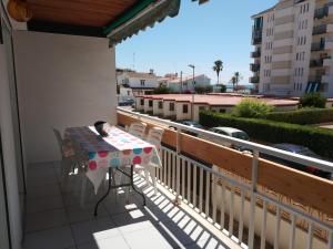 a cat sleeping on a table on a balcony at Costadaurada2000 Sunset Beach Cunit in Cunit