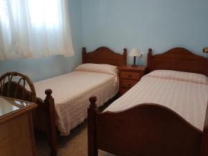 a bedroom with two beds and a dresser at Costadaurada2000 Sunset Beach Cunit in Cunit