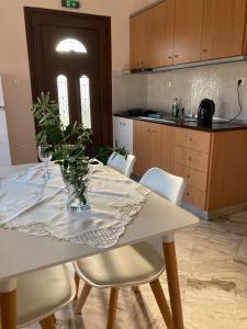 a kitchen with a table with a vase on it at Villa Eleon 1 in Nea Vrasna