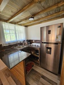 a kitchen with a large stainless steel refrigerator at Chitos place in Savegre