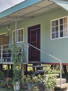 a house with a porch and a door at Chitos place in Savegre