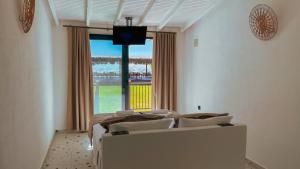 a bedroom with two beds and a large window at Thanos Hotel in Muğla
