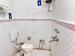 a bathroom with a toilet and a shower at Happy Trails Hostel Udaipur in Udaipur