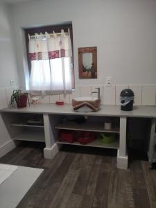 a desk with a mirror in a room at Chez So et Compagnie in Saint-Gérand-de-Vaux +5 photos