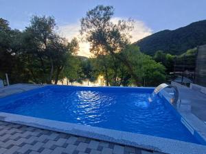 a pool with a water fountain in the middle at Villa Una Verde in Bosanska Krupa
