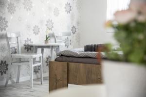 a bedroom with a bed and two tables and chairs at Víkend Apartmanok in Révfülöp +21 photos