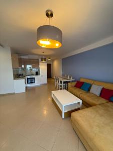 a living room with a couch and a table at Leonard's Shengjin Apartments in Lezhë