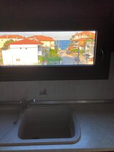 a kitchen sink with a window with a view of a beach at Villa Eleon 2 in Nea Vrasna +24 photos