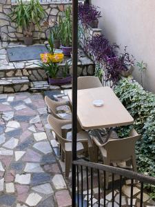a table and chairs on a patio with flowers at Nestorovski House in Bitola