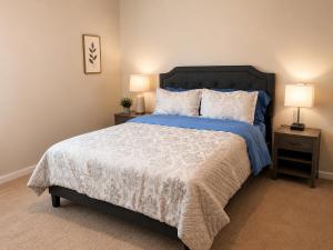 a bedroom with a bed and two night stands with lamps at Guest House Haven with Gazebo in Riverdale