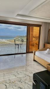 a bedroom with a bed and a view of the ocean at zahara appartement in Tangier +290 photos