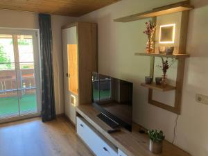 a living room with a flat screen tv on a wall at Ferienwohnung Eble bei Markt Rettenbach in Markt Rettenbach