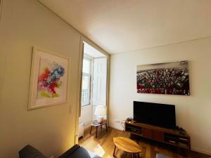 a living room with a flat screen tv on a wall at Lux Old Town in Lisbon