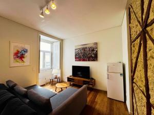 a living room with a couch and a refrigerator at Lux Old Town in Lisbon
