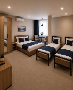 a hotel room with two beds and a table at Sultanahmet Hotel in Baku +60 photos