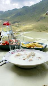 a table with two plates of food on it at Sylbica Guesthouse in Tropojë