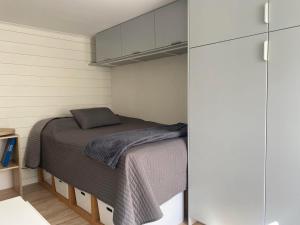 a bedroom with a bed in a small room at Centralt Semesterboende in Halmstad