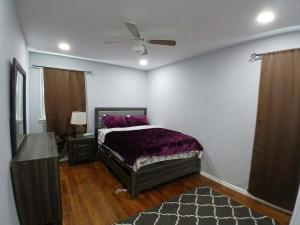 a bedroom with a bed and a ceiling fan at 16 sycamore rd in Bayonne