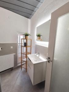 a white bathroom with a sink and a window at Wohnung mit hist. Altstadt Charme in Nördlingen +23 photos